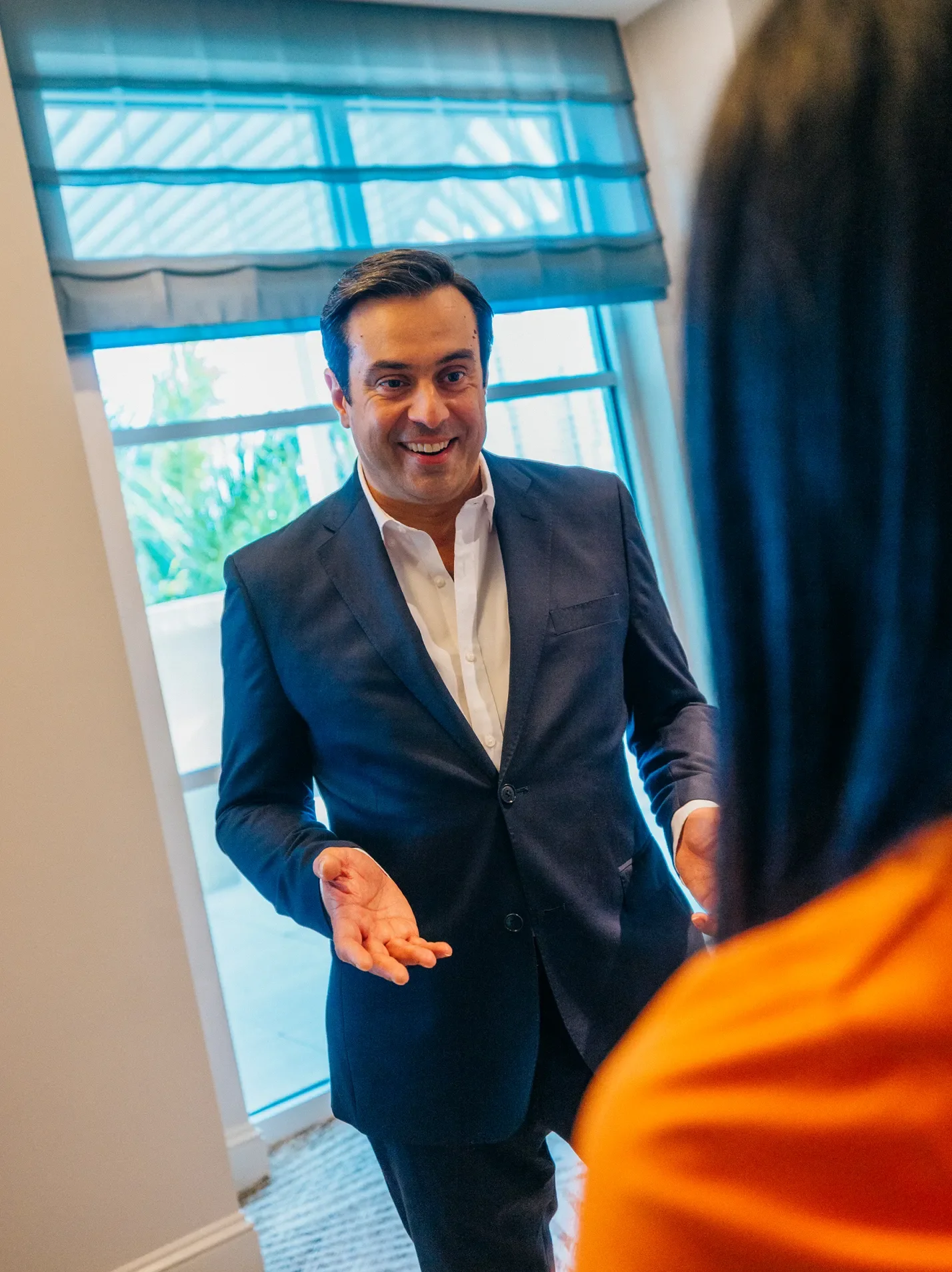 Man in a suit talking to a woman in an office building