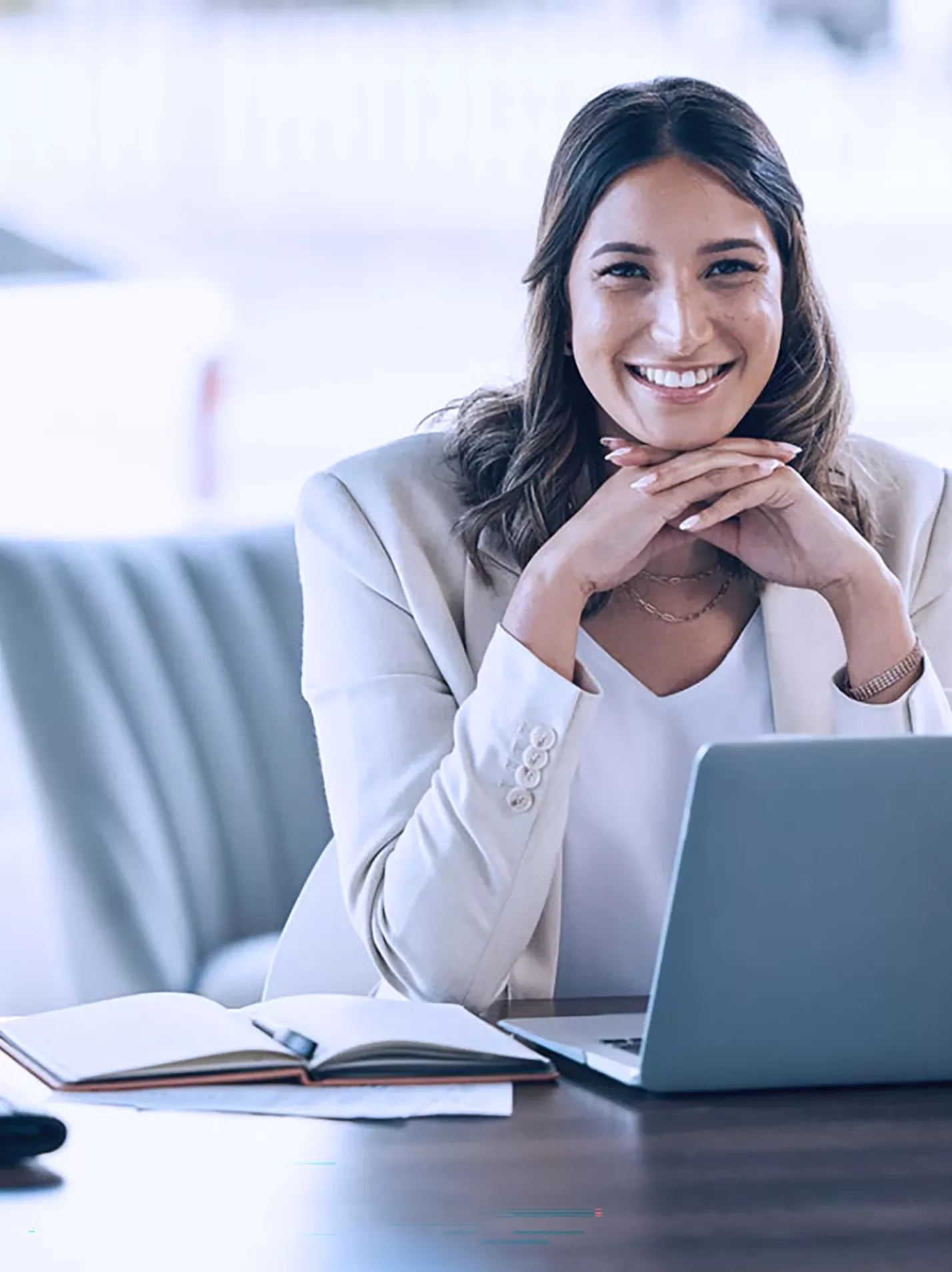 Woman at a laptop smiling virtual workplace training
