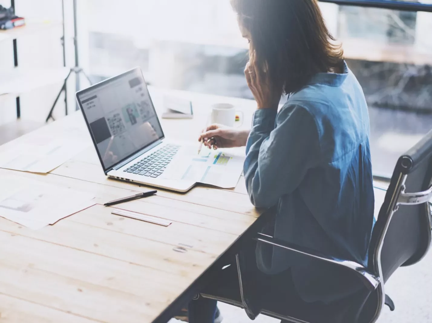 Woman on phone at laptop