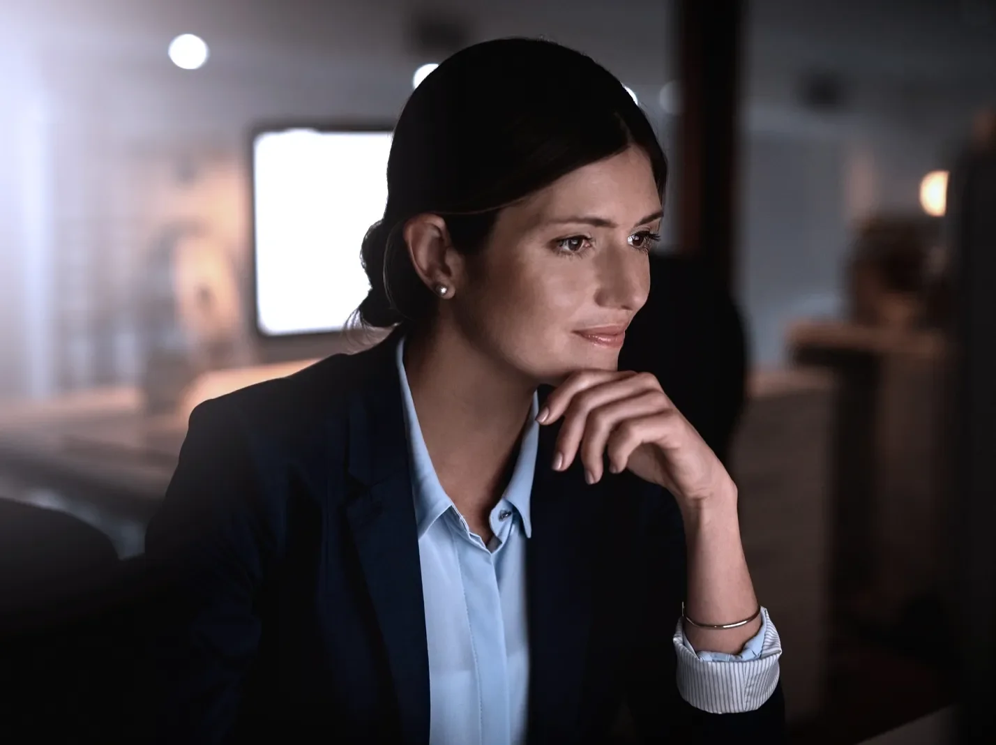 woman in a suit working at a computer