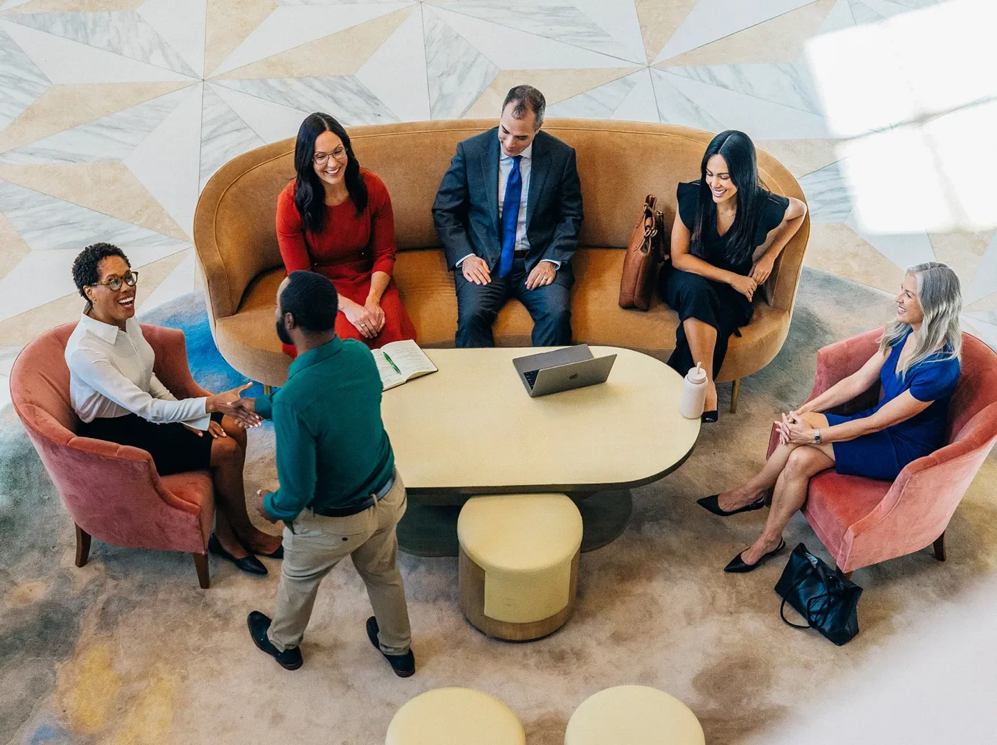 Overhead view of people sitting around a table in a building lobby