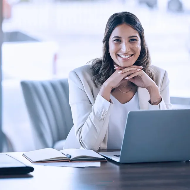 Woman at a laptop smiling virtual workplace training