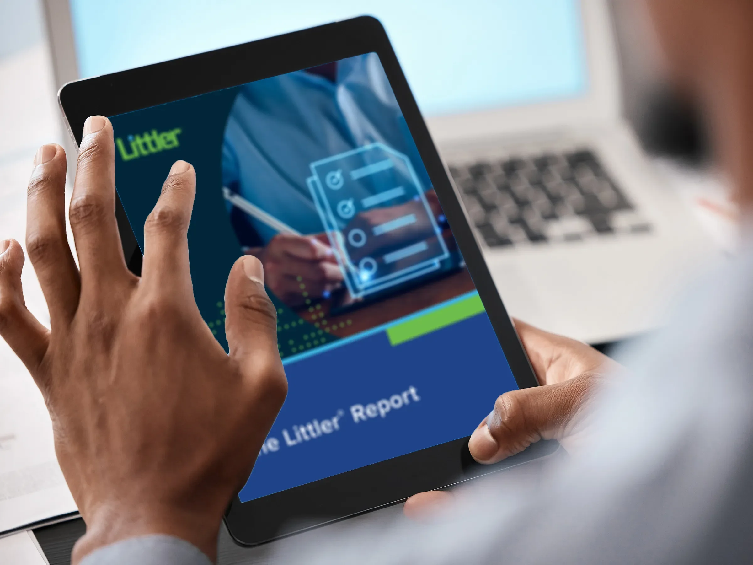 A man reads a Littler Report on a tablet